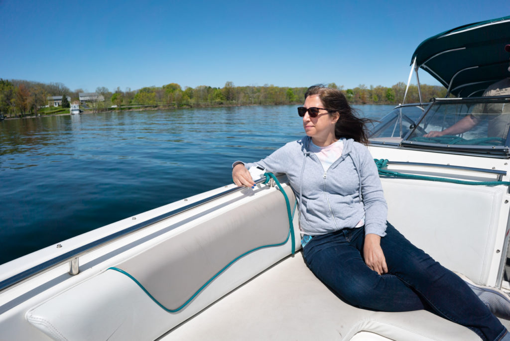 Woman on a speed boat on Cayuga Lake in the Finger Lakes, NY.