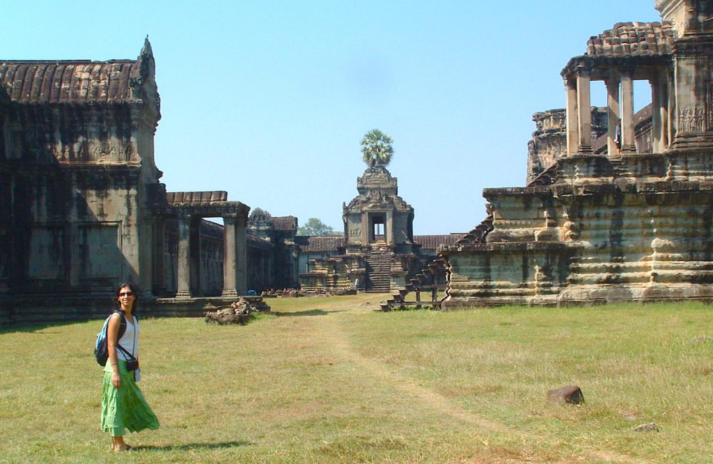 Woman standing in front of ancient temples at Angkor Was, Cambodia. 